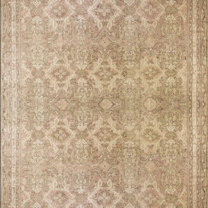 Ornate traditional rug with an all-over diamond pattern in faded pink, tan, and muted brown colors.