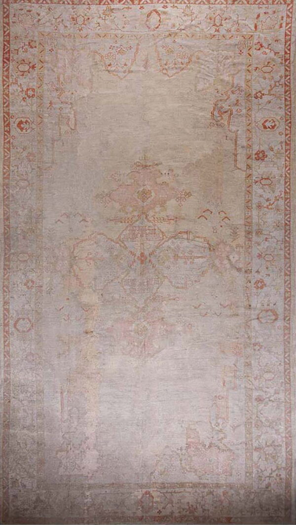 A distressed rectangular area rug featuring a faded traditional pattern in pale gray and muted rust orange.