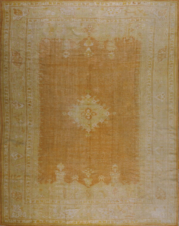 Low-pile rug with a burnt orange field and pale yellow traditional border and medallion pattern.