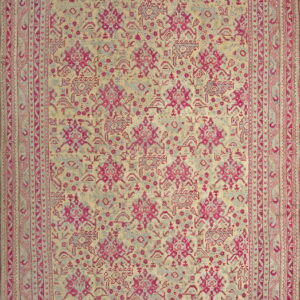 A rectangular rug featuring bright pink and gray geometric motifs on a pale yellow background.