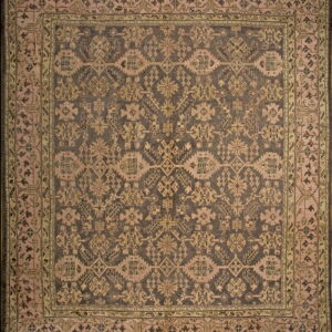 Square rug with a dark field and dense, geometric motifs in dusty pink and pale olive borders.