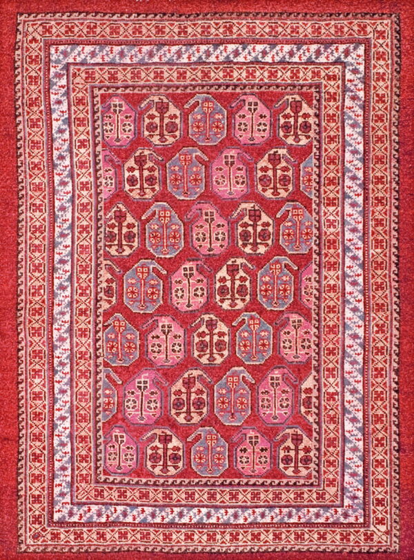 Red rug with repeating pink and blue stylized guls and complex geometric borders.