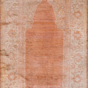 Distressed, shaggy rug in faded blush and ivory featuring a prominent central niche shape.