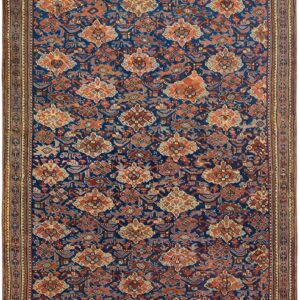 Navy blue runner rug with a repeating pattern of rust orange and brown stylized geometric figures.