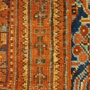 Geometric texture close-up in rust orange, navy blue, and light blue, showing two contrasting pattern panels.