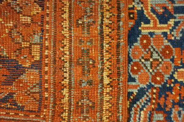 Geometric texture close-up in rust orange, navy blue, and light blue, showing two contrasting pattern panels.