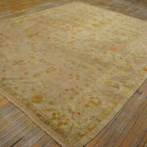 Faded ivory rug with floral patterns.