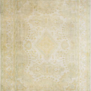 Distressed traditional rug in light cream and faded yellow features a large central medallion and borders.