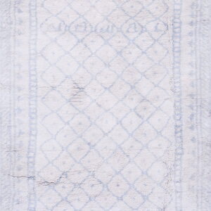 Shaggy white rug featuring a distressed pale blue diamond lattice and a decorative border pattern.