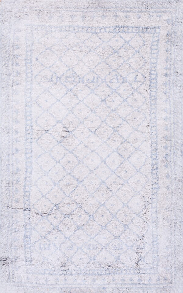 Shaggy white rug featuring a distressed pale blue diamond lattice and a decorative border pattern.