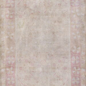 Faded beige rug featuring a subtle central pattern and a wide pale pink floral repeating border.