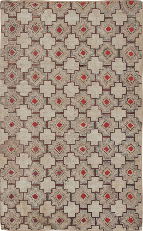 Geometric beige and brown rug featuring an interlocking lattice pattern with bright red diamond accents.