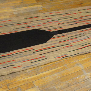 Textured beige runner rug featuring a large black arrow design and multicolored horizontal stripes on hardwood flooring.