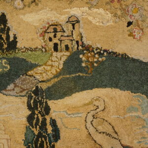 Hooked rug detailed with tan and green hills, a castle, and the word "MEMORIES" on wooden flooring.