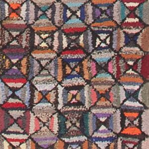 Textured, multicolor runner rug displaying repeating geometric hourglass motifs in shades of red, blue, orange, and purple.