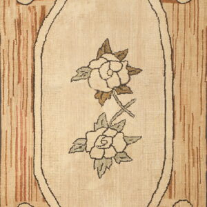 Textured cream rug featuring two roses in an oval medallion border on a striped tan and brown background.
