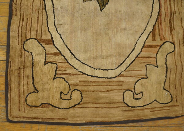 Tan and brown looped-pile rug detail showing bold outlined figures and striped texture on wood planks.