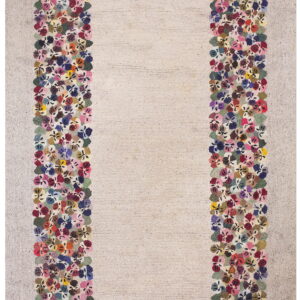 Off-white textured rug with a thick border of densely packed multicolored flowers.