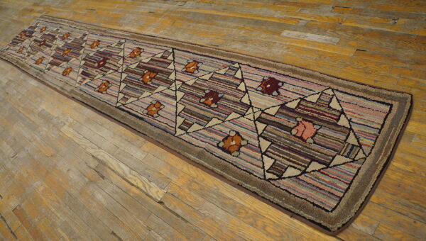 Textured runner rug with striped multicolor background and a diamond floral pattern on distressed wood planks.