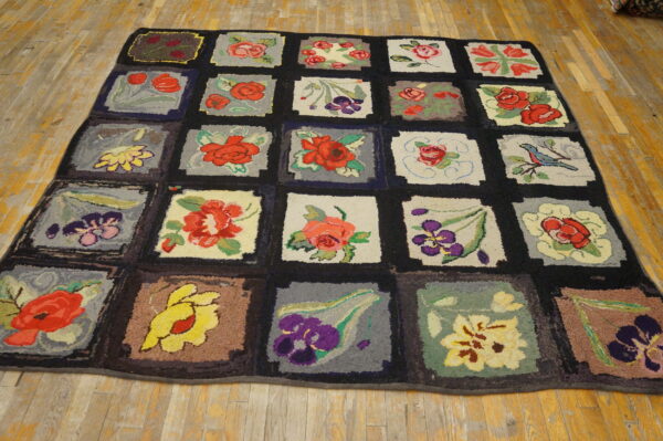 Multicolored patchwork rug with floral and bird designs in chunky texture, displayed on distressed hardwood flooring.