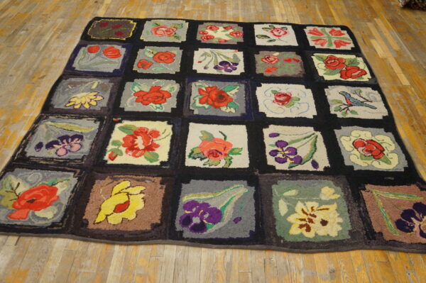 Hooked rug with multicolored floral and bird squares separated by a dark grid on wood floors.