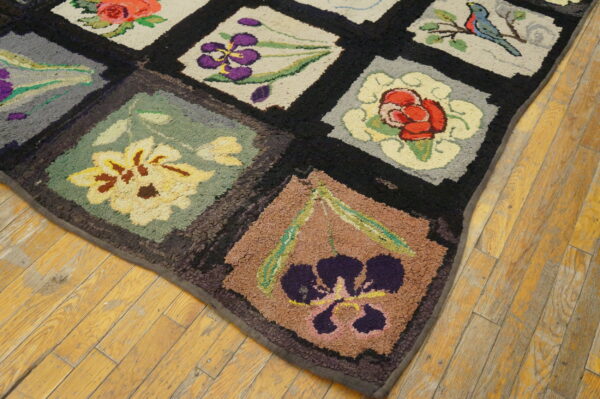 Textured rug with multi-colored floral and bird blocks framed in black on rustic light wood planks.