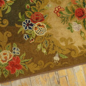 Detailed high-pile rug with red, blue, and gold scrolling florals on a tonal brown background over aged wood floors.