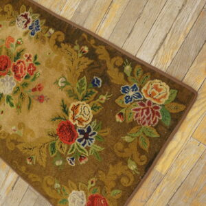 Medium pile rug featuring a colorful floral bouquet pattern on brown and tan, placed on distressed wood planks.