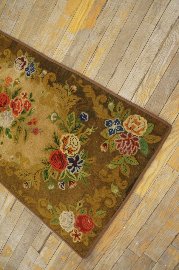 Medium pile rug featuring a colorful floral bouquet pattern on brown and tan, placed on distressed wood planks.