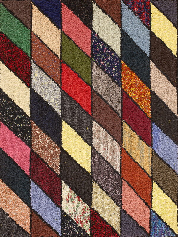 Textured, high-pile rug with a vibrant diagonal lozenge pattern using many solid and speckled colors.