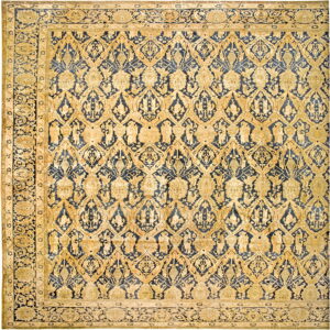 Ornate yellow-gold and indigo rug with a dense repeating geometric and figural design and wide borders.