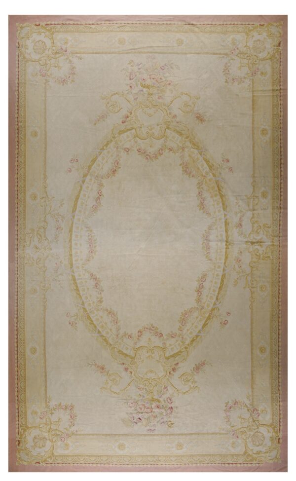 Cream rug featuring a large central oval medallion surrounded by pink floral garlands and gold scrollwork.