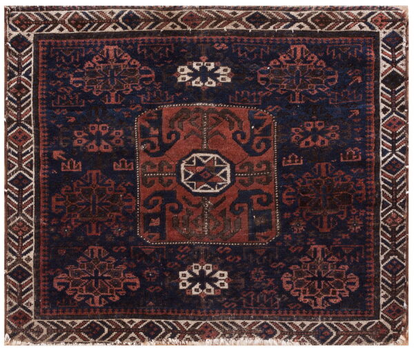 Square geometric rug in deep navy and rust red with a central medallion and complex geometric borders.