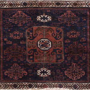 Square rug with a dark blue field, terracotta and black traditional motifs, and a geometric border.