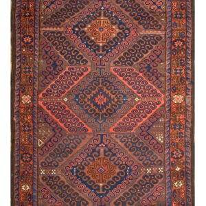 Geometric rug featuring stacked diamond medallions and scroll patterns in brown, blue, and red colors.