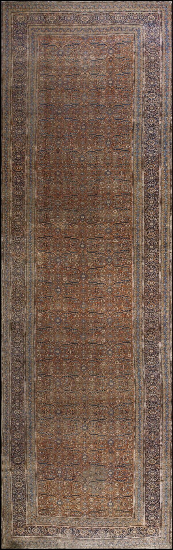 Low-pile runner featuring an intricate blue and tan pattern set against a rich reddish-brown background.