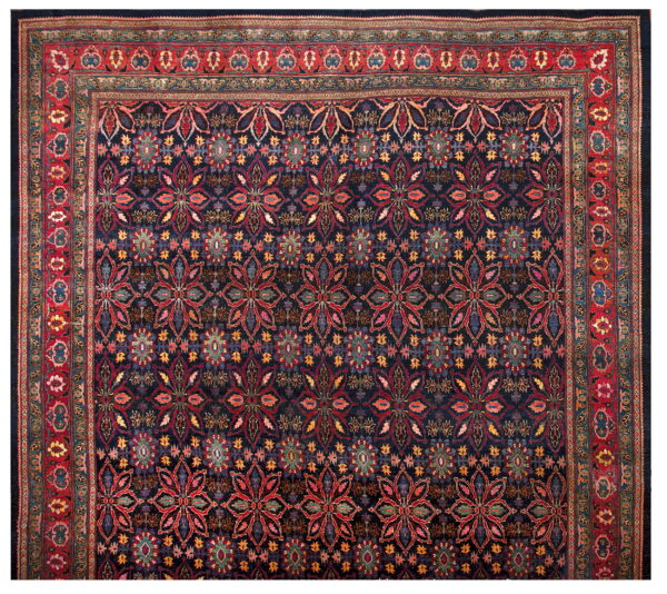 Dark blue traditional rug with a detailed repeating floral pattern and wide multi-banded red border.