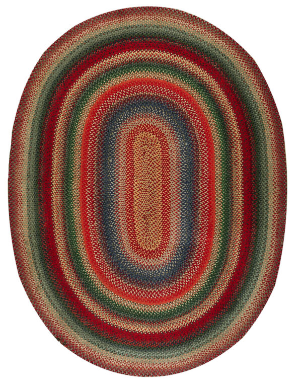 Textured, braided oval rug in concentric bands of mottled red, green, blue, and tan colors.