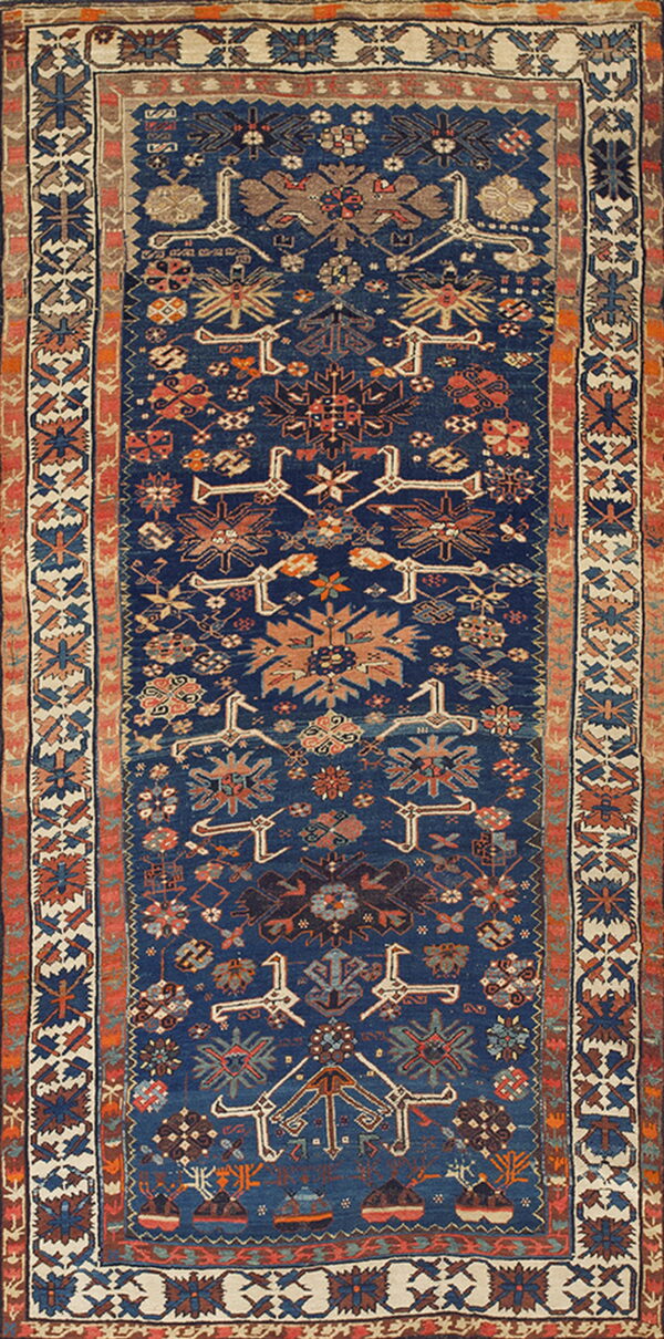 Geometric runner rug with a navy blue field, contrasting ivory border, and rust and tan tribal motifs.