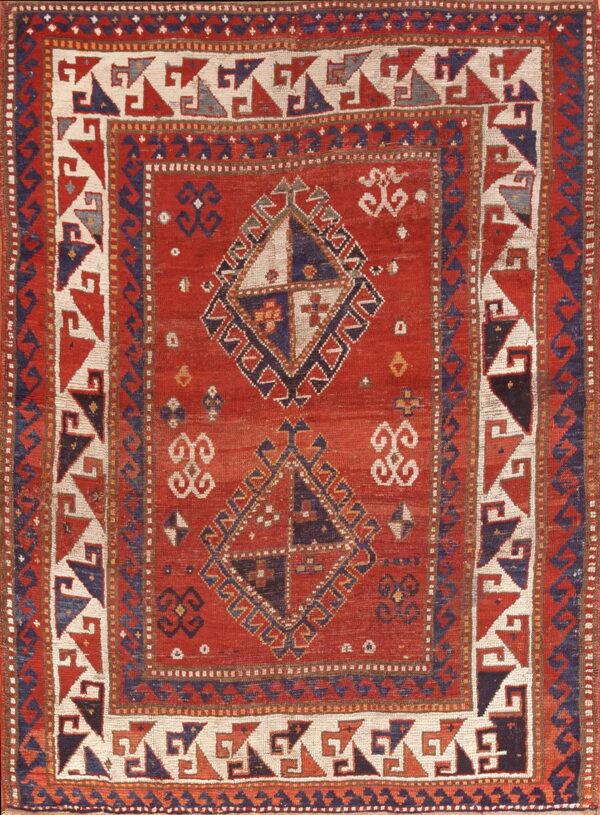 Low-pile red rug featuring geometric medallions and intricate borders in cream, navy, and rust colors.