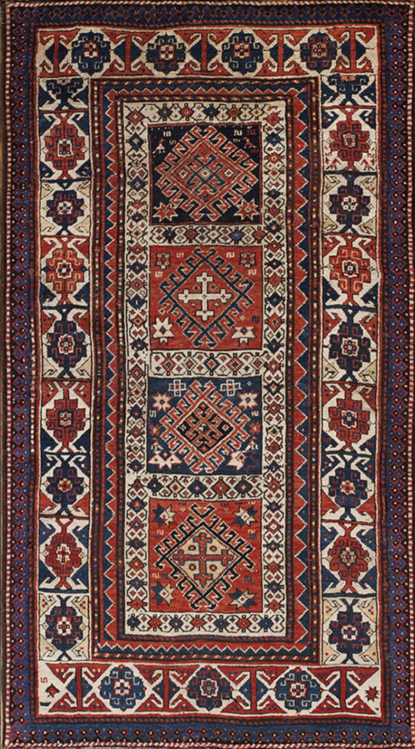 Low-pile geometric rug in navy blue, red, and cream featuring stacked central medallions and wide borders.