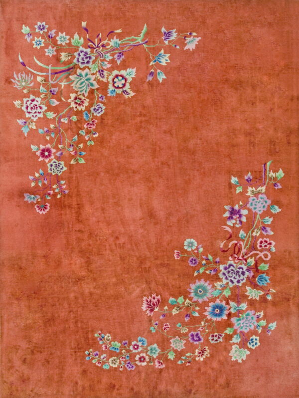 High-pile rust rug with asymmetrical bouquets of purple, blue, and green flowers in the corners.