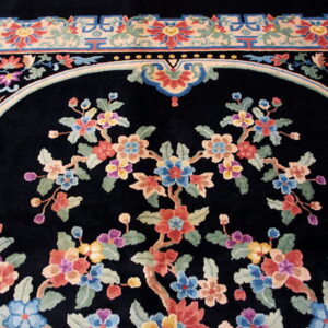 Black rug with multicolored floral design, a central arched field, and a detailed geometric border.