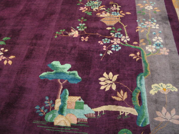 Plush purple rug with a gray stripe border and a detailed botanical scene of trees, flowers, and a structure.