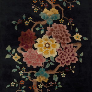 Plush black rug displaying an elaborate floral pattern of pink, gold, teal, and burgundy blooms on brown branches.