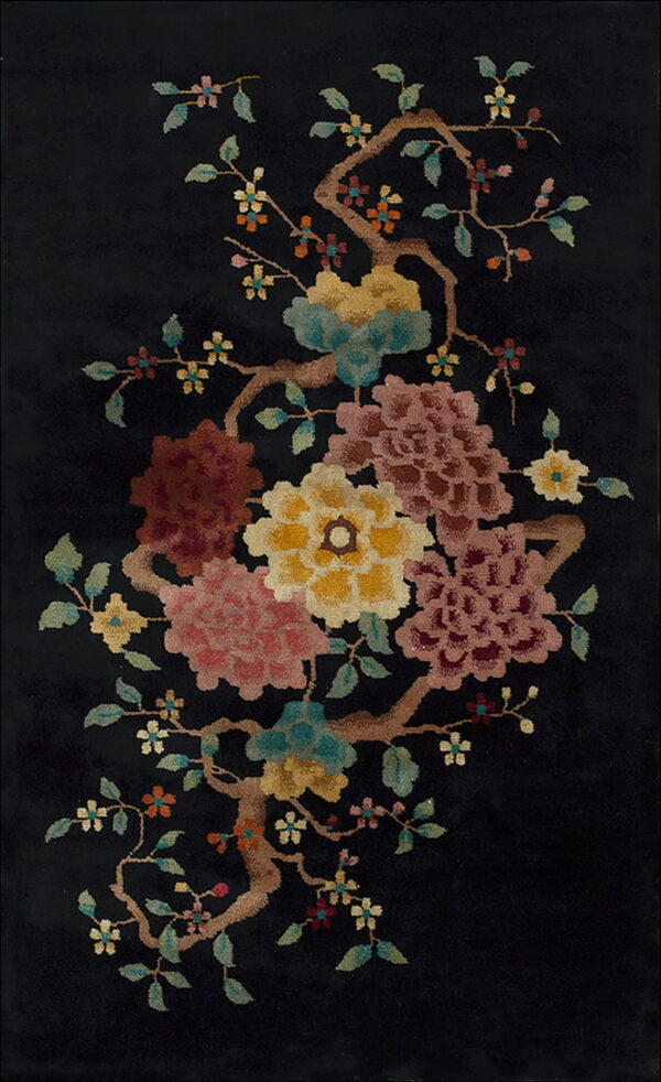 Plush black rug displaying an elaborate floral pattern of pink, gold, teal, and burgundy blooms on brown branches.