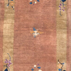 Muted rose rug with an olive border and scattered blue, white, and gold floral and bird designs.