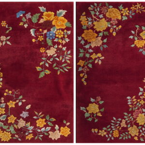 Deep red rug with lush, multi-colored floral and vine motifs clustered around the perimeter.