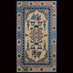 Tan rug with navy blue and rust geometric borders framing stylized architecture, vases, and detailed symbolic patterns.