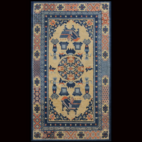 Tan rug with navy blue and rust geometric borders framing stylized architecture, vases, and detailed symbolic patterns.
